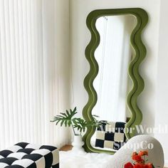 a mirror sitting on top of a wooden floor next to a white chair and ottoman