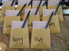 several pieces of paper with writing on them sitting on top of a counter next to scissors