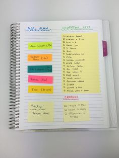 a spiral notebook with notes and stickers on it