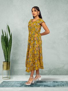 Embrace elegance with our Tranquil Threads yellow knee-length dress. Featuring a stunning print, this dress is perfect for everyday wear or a night out in the city. Crafted with care for the modern woman who values both comfort and style. Key Specifications : Material Kalankari Silk Occasion Casual Type Fusion/Indowestern Knee-length Printed Sundress, Printed Knee-length Sundress, Printed Fitted Knee-length Sundress, Fitted Knee-length Printed Sundress, Printed Sundress In Midi Length, Printed Sundress Midi Length, Yellow Floral Print Knee-length Dress, Flowy Knee-length Floral Sundress, Elegant Yellow Printed Dress