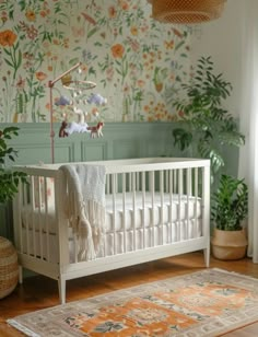 a white crib in a room with flowers on the wall and plants behind it