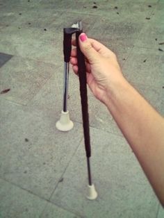 a hand holding two black and white poles