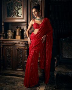 This red net saree features tonal sequin embroidery in a linear pattern. It is paired with a fully embroidered strappy blouse.From Seema Gujral's Kashish collection DELIVERY TIMEPlease allow 8-12 weeks for your outfit to arrive. FABRIC DETAILSNet Professional cleaning only. Red Net Saree, Red Sequin Saree, Strappy Blouse, Seema Gujral, Red Sari, Sequin Saree, Fancy Sarees Party Wear, Simple Sarees, Saree Designs Party Wear