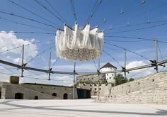 there are many electrical wires above the ground and buildings in the background with blue sky