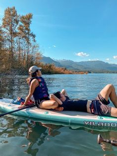 two people on a paddle board in the water