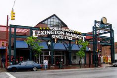 a car is parked in front of a market