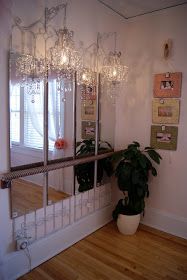 there is a potted plant in the corner of this room with mirrors on the wall