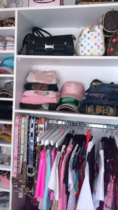 an organized closet with clothes and handbags