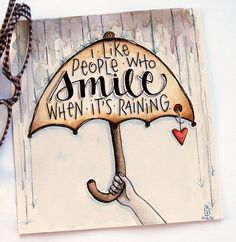 a hand holding an umbrella that says i like people who smile when it's raining