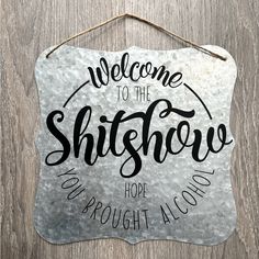 a metal sign that says welcome to the shitshow hope you're proud