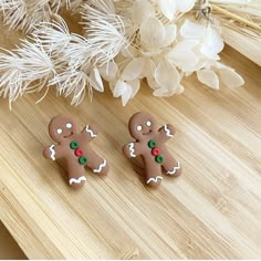 two gingerbread cookies are sitting on a table