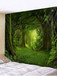 a bed room with a large wall mural on the wall and a forest scene behind it