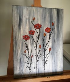 a painting with red flowers painted on it