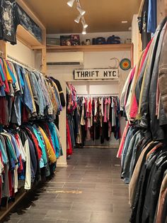 a clothing store with lots of shirts hanging on the walls and clothes hung up in rows