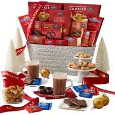 a basket filled with cookies and chocolates next to christmas decorations, candy bars and other treats