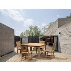 a wooden table and chairs on a deck