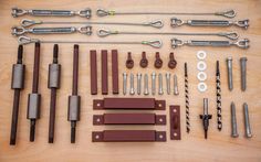 various tools are laid out on a wooden surface with screwdrivers and other hardware