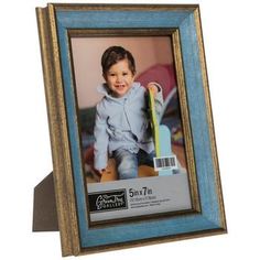 a blue and gold frame holds a photo of a young boy