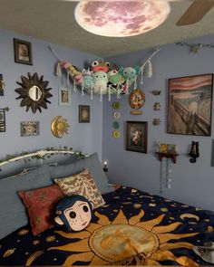 a bed room with a neatly made bed and many pictures on the wall above it