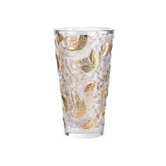 a clear glass with gold leaves on it