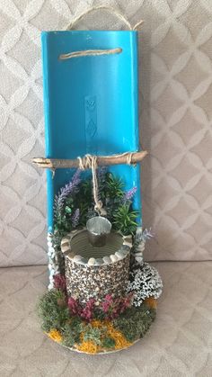 a blue box with plants and rocks in it