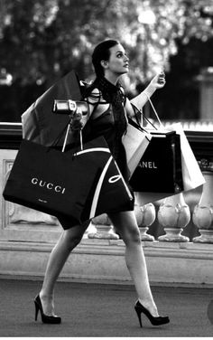 a woman walking down the street carrying shopping bags