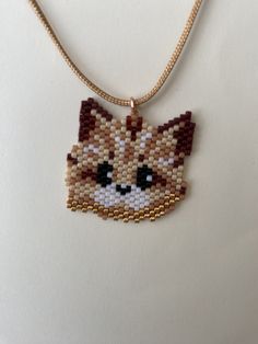 a beaded necklace with a cat face on it