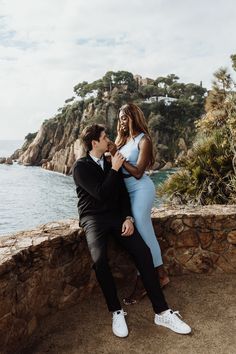 couple looking at each other with sea and Mountain View