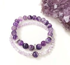 "Amethyst Gemstone Bracelet Set Of Two As a master healer and powerful protection crystal, Amethyst is known as the \"stone of calm.\" This purple beauty emits calming vibrations which help soothe the body, mind, soul and spirit.  Wearing an amethyst bracelet s a lovely way to carry tranquil energy around with you wherever you go.  Features: * Amethyst 8mm * Amethyst 4mm * 925 Sterling Silver bead spacers 4mm * Crystal Pave silver spacers 8mm * Strong Stretch Cord * This is a stretch Amethyst br Amethyst Bracelet Gemstones, Light Purple Bracelet, Gemstone Bracelets Ideas Trendy, Purple Bead Bracelet Ideas, Elegant Stone Bracelet, Amethyst Stone Bracelet, Purple Beads Bracelets, Purple Bracelet Ideas, Bracelet Set Ideas