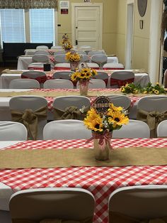 the tables are set up with sunflowers and burlap tablecloths