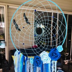 a blue and white dream catcher with roses on it