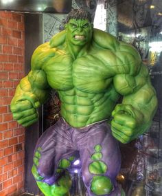 the incredible hulk statue is displayed in front of a brick wall