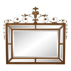 a mirror with an ornate design on the top and bottom frame, hanging from a wall