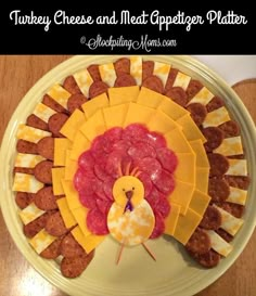 a turkey cheese and meat appetizer platter on a plate with sausages