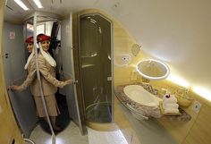 a woman standing in the doorway of an airplane bathroom