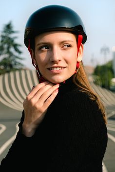 a woman wearing a helmet is posing for the camera