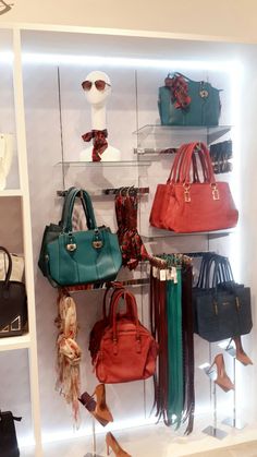 many purses and handbags are displayed on shelves