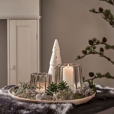 a tray with candles and christmas decorations on it