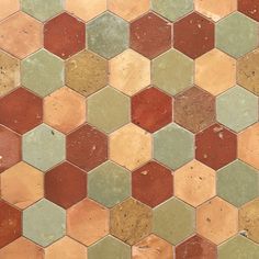 a close up view of a multicolored hexagonal tile