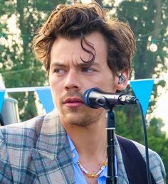 a young man is singing into a microphone