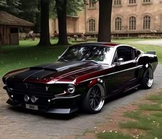 a black and red mustang parked in front of a house