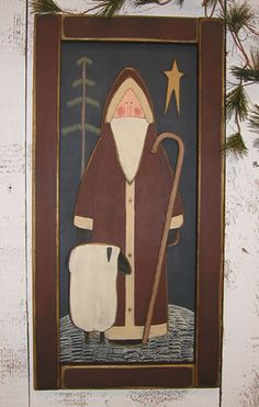 an image of a painting hanging on the wall with pine branches in front of it