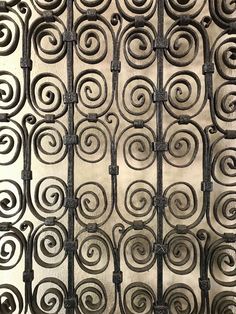 an iron fence with spiral designs on it