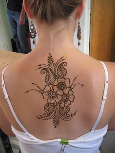 a woman with a tattoo on her back