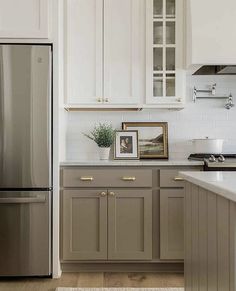 a silver refrigerator freezer sitting inside of a kitchen next to a counter top oven