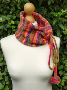 a white mannequin wearing a multicolored scarf