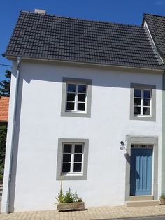 a white house with blue doors and windows