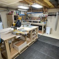 a workbench in a garage with lots of tools on the table and shelves