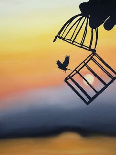 a painting of a bird in a cage with the sun setting behind it and someone's hand reaching out