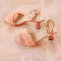 two pairs of pink shoes with pearls on them